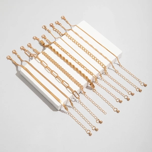 Detail of 10-piece gold chain bracelet set with snake, wheat and paperclip links
