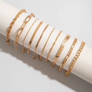 Detail of 10-piece golden bracelet set with rope, paperclip and snake chain designs
