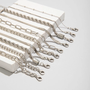 Detailed view of silver mixed link chain bracelets including snake and wheat chain textures