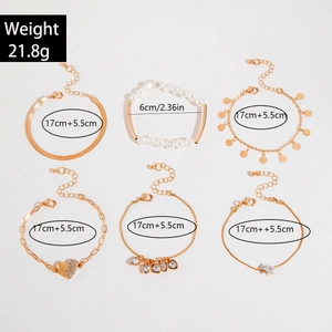 Detail of 6-piece gold chain bracelet set with pearls, hearts, and star charms