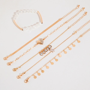 Detail view of 6-piece gold alloy bracelet set featuring pearls and heart charms