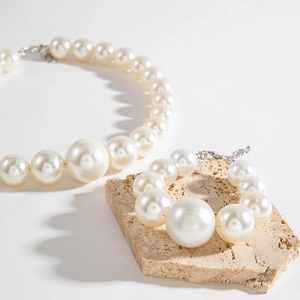Elegant white pearl necklace and bracelet jewelry set with gradient bead sizes
