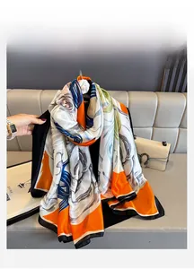 Detail of large floral silk scarf with vibrant orange and blue abstract art patterns