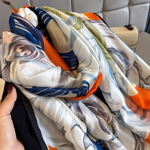 Floral silk satin shawl with vibrant orange and blue patterns for elegant sun protection