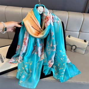 Sky blue silk satin scarf with floral prints and orange gradient for sun protection