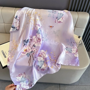 Detail of lavender floral silk satin scarf showing smooth texture and elegant prints