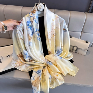 Elegant silk satin scarf with blue floral and butterfly prints on light yellow background