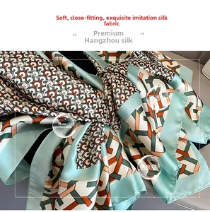 Detail of faux silk scarf fabric showing smooth texture and geometric print patterns