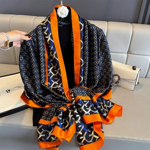 Summer silk scarf with blue geometric grid patterns and orange border in a stylish setting