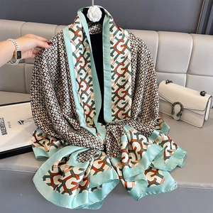 Elegant summer printed silk scarf with mint green geometric patterns and satin finish