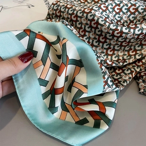 Summer silk scarf with mint green geometric chain patterns for sun protection and styling