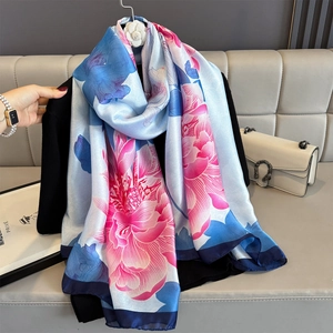 Elegant floral silk-like scarf featuring pink peony patterns and navy blue borders