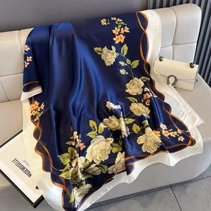 Detailed view of dark blue silk shawl with beige rose prints and satin luster finish