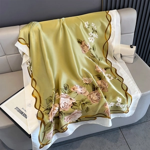 Detail of olive green floral silk scarf with pink roses and elegant golden wavy patterns