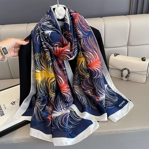 Blue silk shawl with vibrant feather print and white borders for sun protection