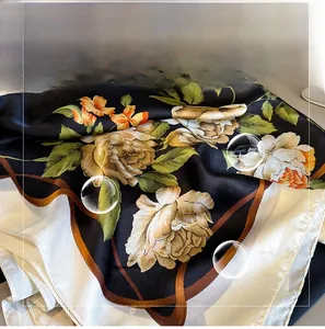 Close-up of elegant floral print scarf showing soft imitation silk fabric and texture