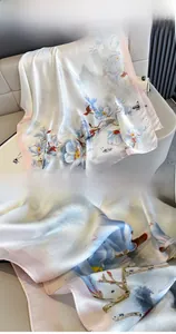 Detail of premium silk satin scarf with floral magnolia print and fine stitched edges
