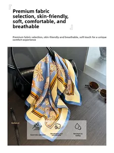 Silk square scarf with blue and yellow prints draped on a luxury black leather handbag