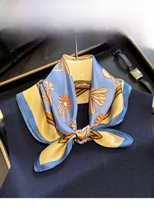 Macro shot of 100% mulberry silk square scarf with abstract patterns on blue fabric