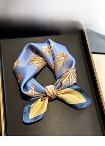 Detailed close-up of 100% mulberry silk square scarf with vintage shell print patterns