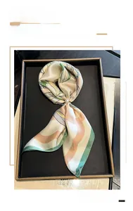 Detail of 100% mulberry silk square scarf with magnolia print and pearl buckle