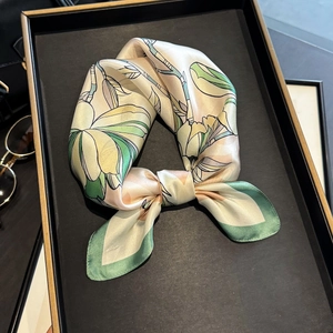 Premium mulberry silk square scarf with magnolia floral print and green hem in tray