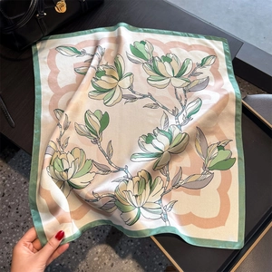 Luxurious magnolia print silk scarf in light beige with elegant green borders