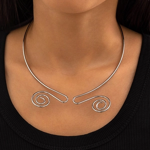 Detailed view of silver vintage choker necklace with spiral metal scroll ends on model