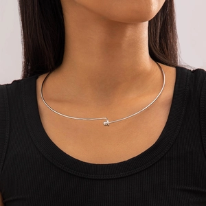 Detail shot of vintage silver-tone metal choker necklace on model with bead closure