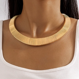 Detailed close-up of golden wide choker necklace featuring vertical pleated metal texture