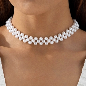 Close-up of double-layered woven white pearl choker necklace on a model's neck