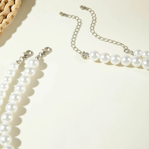 Detail of double-layer faux pearl necklace with adjustable silver lobster clasp and chain