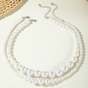 Close-up of double-layer pearl necklace with lobster clasp and adjustable silver chain