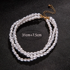Three-layer faux pearl necklace featuring 31cm length with a 7.5cm gold extender chain