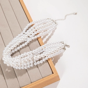 Detail of multilayer pearl necklace with silver lobster clasp on velvet display