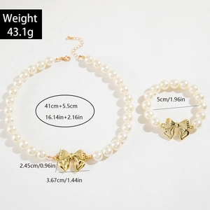 Dettaglio di set collana e bracciale di perle con fiocchi dorati e specifiche taglie