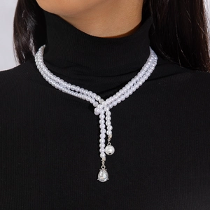 Close-up of double-layer faux pearl necklace with teardrop crystal and Y-shape pendant