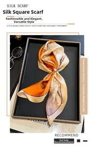 Detail of 100% mulberry silk square scarf with floral print on a black jewelry tray