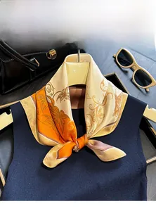 Detailed view of a 100% mulberry silk scarf with butterfly and floral patterns in bright orange