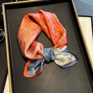 Elegant paisley print silk square scarf with orange and navy blue floral patterns