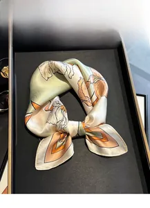 Detail of 100% mulberry silk scarf with floral patterns on a display tray
