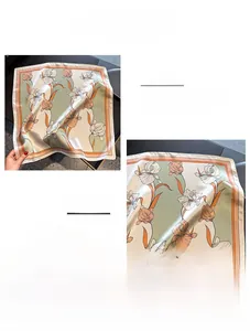 Detail of silk square scarf featuring iris floral print and delicate hand-rolled edges