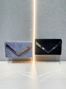 Luxury velvet envelope clutch bags in purple and black with silver V-shaped metal trim