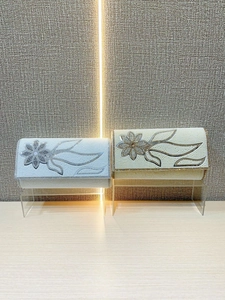 Elegant pearl evening clutch with sparkling crystal floral patterns in silver and gold