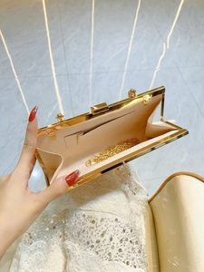 Elegant champagne pleated evening clutch with golden frame and detachable chain strap
