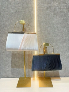 Elegant pleated evening clutch with golden metal handle in champagne and navy blue