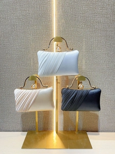 Elegant pleated satin evening clutch bags in white and gold with pearl clasps