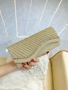 Champagne gold glitter evening clutch bag with pleated design and rhinestone detail