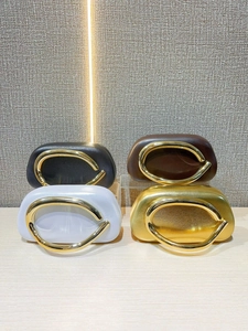 Luxe evening clutch bags in black, brown, silver, and gold with gold metal ring handles