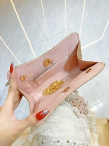 Sparkling gold evening clutch bag with pearl chain strap and pink fabric lining